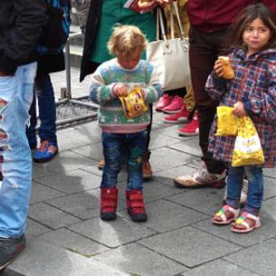 Refugees Munich Girl Smile Food Happy Munich Hauptbahnhof Central railway station Refugees Munich Girl Smile Food Happy-Photojournalist Kilian Tribbeck photojournalistic series on refugees from Syria and asylum seekers from Syria Afghanistan and Irak in Munich on 500px.com